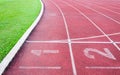 Numbers starting point on red running track,running track and green grass Royalty Free Stock Photo