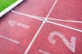 Numbers starting point on red running track,running track and green grass Royalty Free Stock Photo