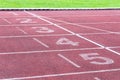 Numbers starting point on red running track,running track and green grass