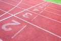 Numbers starting point on red running track,running track and green grass Royalty Free Stock Photo