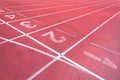 Numbers starting point on red running track,running track and green grass Royalty Free Stock Photo