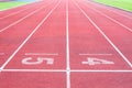 Numbers starting point on red running track,running track and green grass Royalty Free Stock Photo
