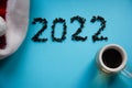 2022. Numbers Tea leaves 2022 on blue background. Flat lay, top view, copy space