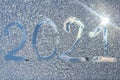 The numbers 2021 traced on a frozen window.