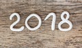 Numbers from white clay forming the number 2018, Element for a postcard new year 2018 on a rustic wooden background.