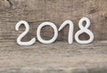 Numbers from white clay forming the number 2018, Element for a postcard new year 2018 on a rustic wooden background. Royalty Free Stock Photo