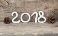 Numbers from white clay forming the number 2018, Element for a postcard new year 2018 on a rustic wooden background. Royalty Free Stock Photo
