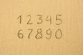 Numbers written on a sandy beach.