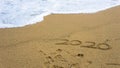 Numbers 2020 year on the sea shore, message handwritten in the golden sand on beautiful beach background Royalty Free Stock Photo