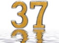 Numeral 37, thirty seven, reflected on the water surface