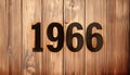 1966 numerals stencilled on a wooden background