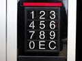 Numeric keypad with large digits on vending machine or self service kiosk, black control panel, pin code entry buttons, payment Royalty Free Stock Photo