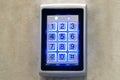 The numeric keypad is mounted on the wall. Blue keyboard light