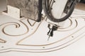 Numerically controlled woodworking machine cuts rounded complex lines on the canvas. Computer numerical control. CNC. Royalty Free Stock Photo