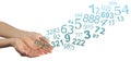 Numerology Concept with random numbers flowing from cupped hands Royalty Free Stock Photo