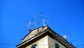 Numerous antennas and TV dishes on an ancient building, typical of many Italian cities.