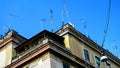 Numerous antennas and TV dishes on an ancient building, typical of many Italian cities