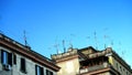 Numerous antennas and TV dishes on an ancient building, typical of many Italian cities.