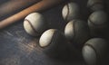 Numerous balls and bats on wooden table