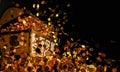 Numerous gold coins spilled out from the treasure chest. Old-style wooden treasure chest tightly assembled with rusted metal