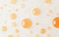 Numerous golden droplets scattered on a smooth white surface create an artistic water design, showcasing light Royalty Free Stock Photo