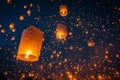 Numerous lanterns fill the sky as they gracefully float through the air, creating a mesmerizing sight, Glowing lanterns floating