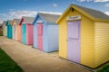 Numerous multi coloured beach huts