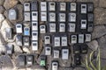 numerous security boxes with password controlled locking for the storage of keys of holiday flats at the entrance of a building,