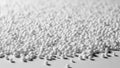 Numerous small spherical polystyrene beads are scattered across a flat surface Royalty Free Stock Photo