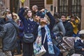 Numerous tourists are photographed in the courtyard of Juliet`s house. People make selfies