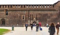 Numerous tourists and residents walk around the yard of the fortress Sforzesco Castle in Milan, Italy