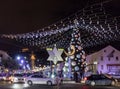 Numerous tourists view the Christmas tree decorated with toys, the Christian cross, the Judean Menorah, and the Muslim Crescent in