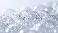 Closeup of transparent soap bubbles in various sizes on white surface with soft focus background Royalty Free Stock Photo