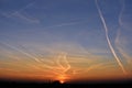 Contrails in the sky at sunset