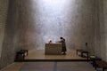 A nun at an alter inside the Notre Dame du Haut chapel in Ronchamp, France Royalty Free Stock Photo