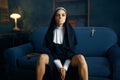 Nun in a cassock sitting spreading her legs Royalty Free Stock Photo