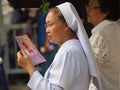 Nun holding book