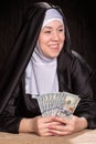 Nun holds dollars Royalty Free Stock Photo