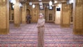 Nun in Robe Stands Inside an Islamic Mosque. Egypt