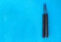 Nunchaku weapon isolated on Blue background. Black nunchaku training for beginner. Hot Tactical Gear Martial Arts Equipments