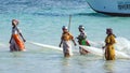 Nungwi, Zanzibar, Tanzania, East Africa - June 23, 2017: African women from a fishing village to catch small fish nets in the ocea