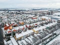 Nupaky, Czech republic. January 10, 2019. New coloured row houses with old part of village in background in winter with snow