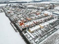 Nupaky, Czech republic. January 10, 2019. New coloured row houses with old part of village in background in winter with snow