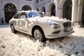 Nuptial charm White wedding car decorated with flowers and rose petals