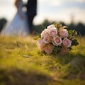 Nuptial scene Wedding bouquet rests on grass with married couple Royalty Free Stock Photo