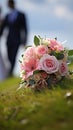 Nuptial scene Wedding bouquet rests on grass with married couple