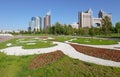 NUR-SULTAN, ASTANA, KAZAKHSTAN - JUNE 3, 2015: City view to the flowerbed with ornament of petunia flowers with skyscapper