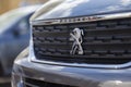 Peugeot logo on a Peugeot car at a car dealer