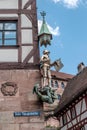 Saint George and the Dragon statue at half timbered building corner on Beim Tiergartnertor, Altstadt Old Town in Nuremberg,