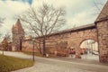 Historical brick walls of Old City with arched entrance with stone towers